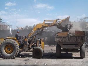 volunteers removing rubble and garbage from the devastated camp